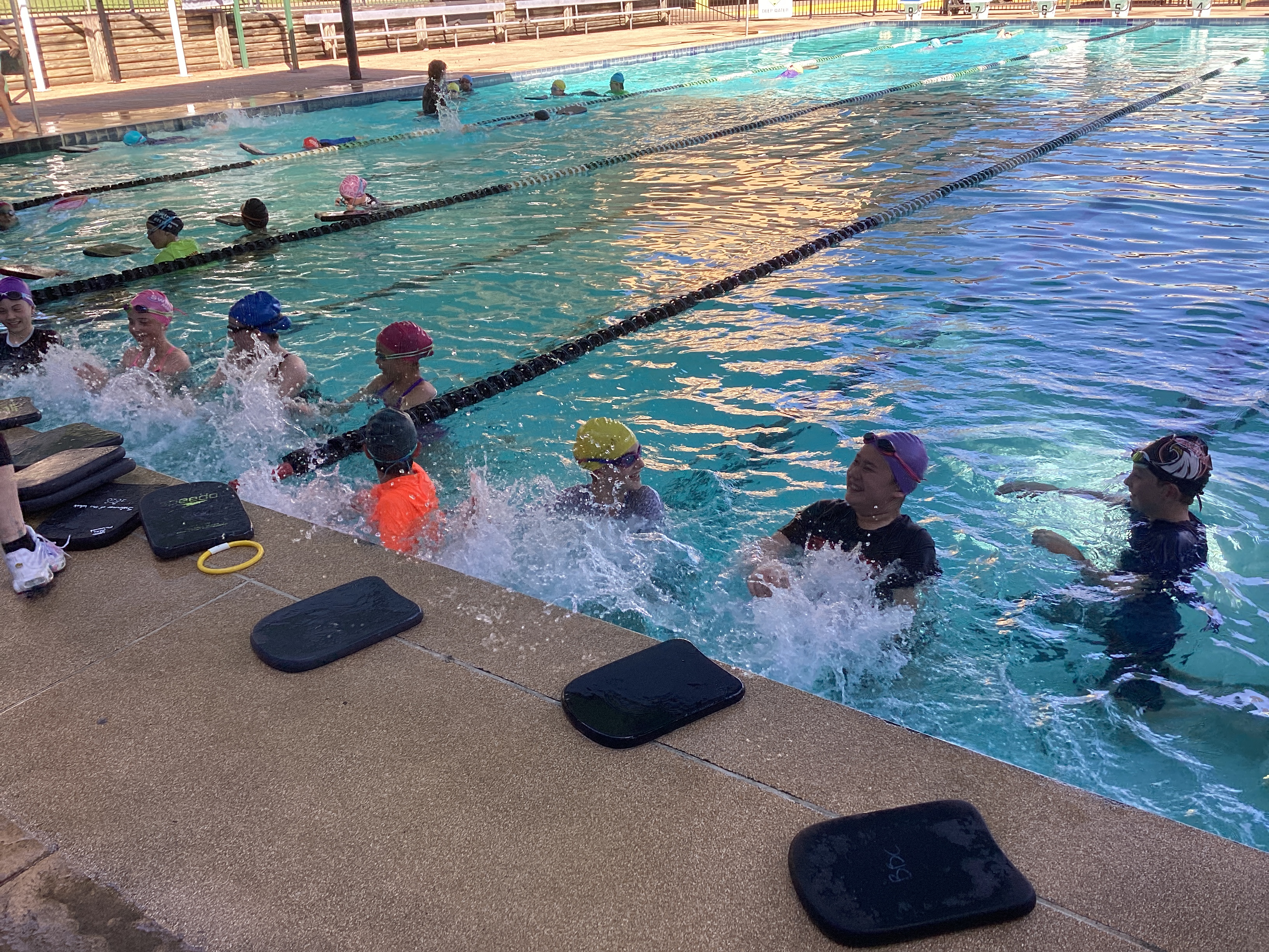 Students practising swimming skills during a school lesson.