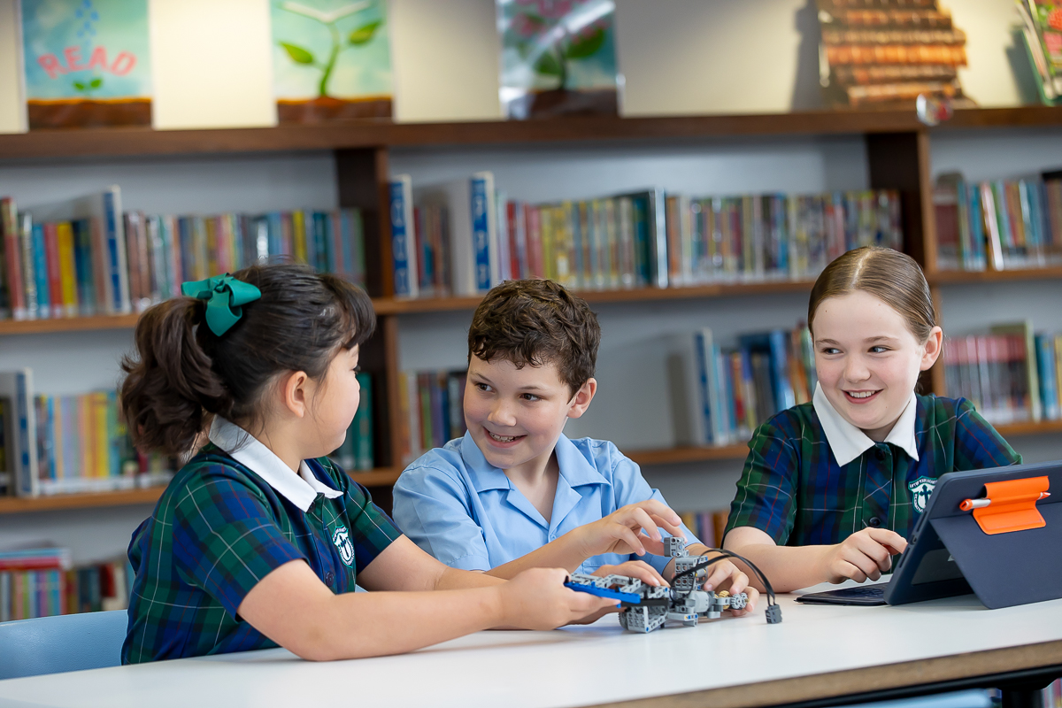 Students collaborating on a robotics learning activity in the school library.