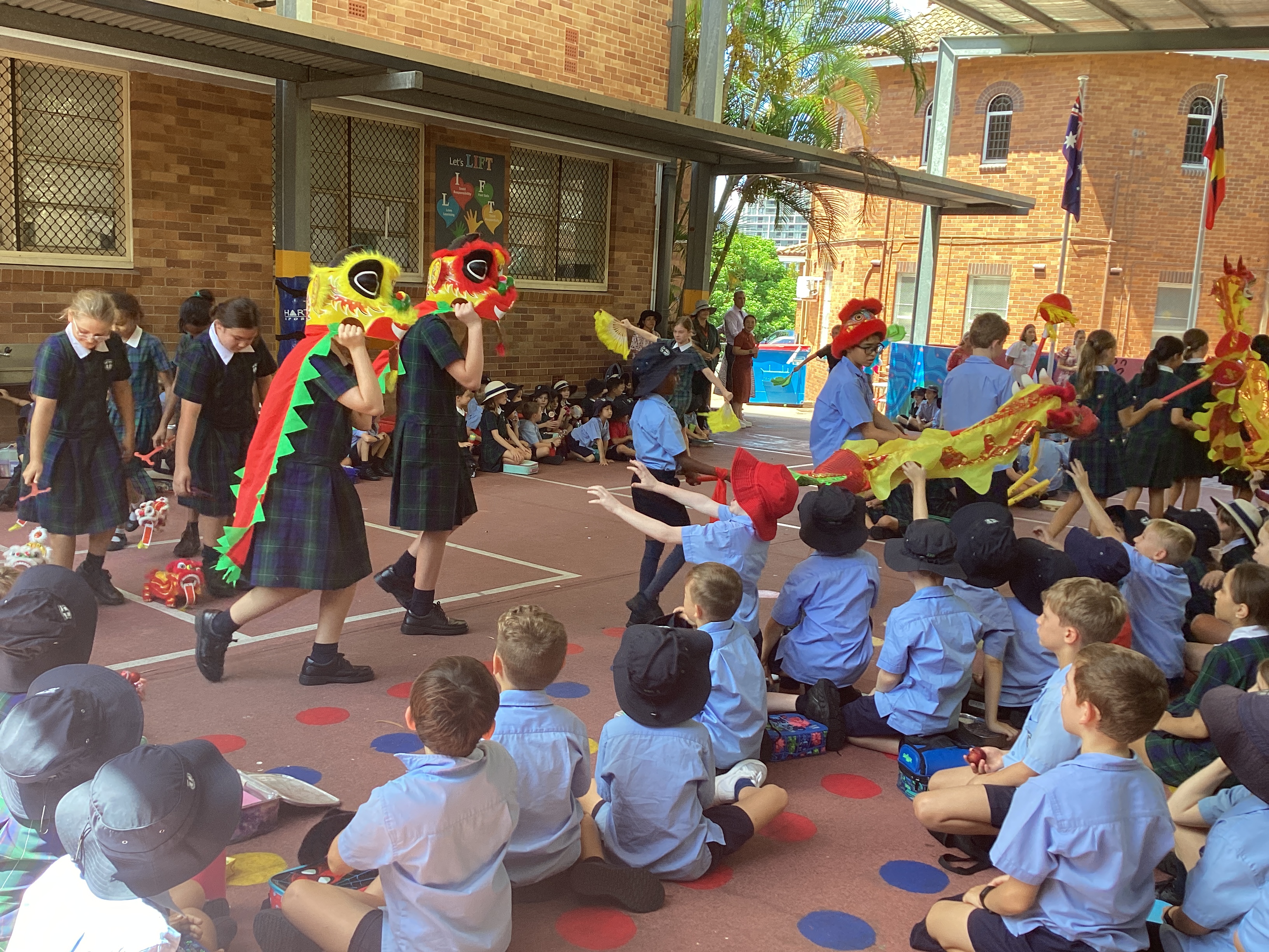 Students performing a dragon dance at a school assembly.